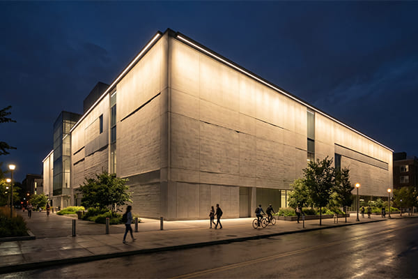 A wide wall washer light evenly illuminating a large, flat building wall.